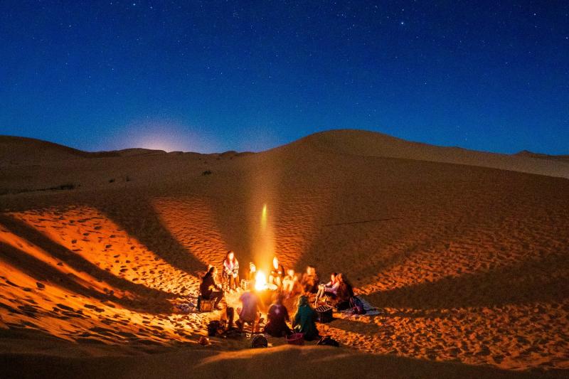 Have a bonfire gathering at a nearby secluded place to lessen the glare of the fire