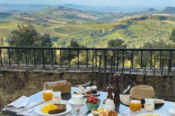 Breakfast at Borgo Pignano resort with a view of the Tuscan hills